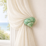 Jade Turbo Seashell Drapery Medallion Holdback – Coastal Curtain Tieback for Beach House Windows, measuring 3 - 4" L.  Comes with a wall mount bracket with a 3"-5" projection.