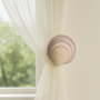 Pink and cream clam tiger seashell drapery medallion – 3″ +/- Diameter with a 3″ – 5″ projection.