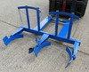 A double mauser drum grab in blue carrying no barrels while attached to a forklift