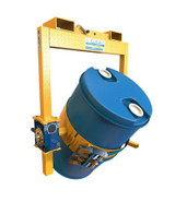 A yellow crane slung drum rotator with a crank handle carrying a drum on a white background