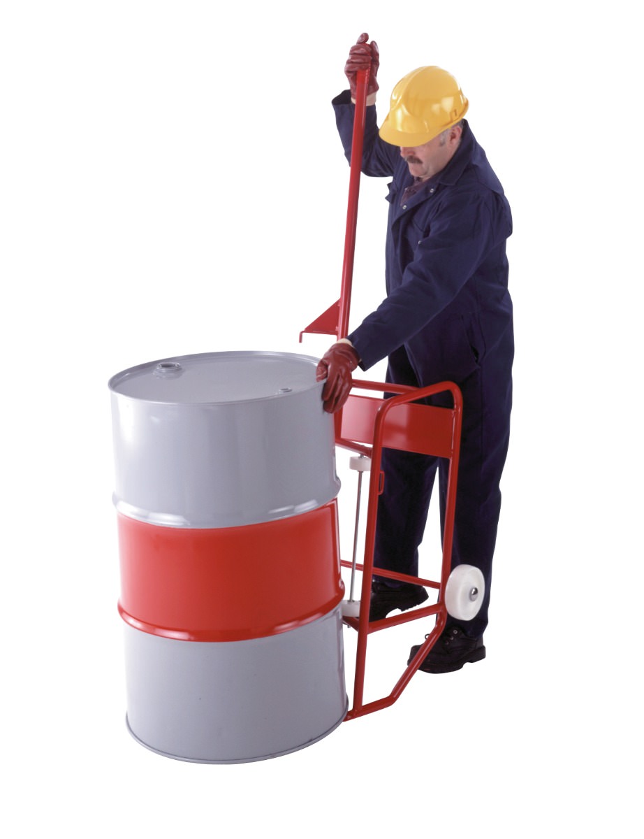 A mobile red drum stand with wheels having a grey drum with a red stand loading onto it by a man in navy blue overalls and a yellow hard hat.