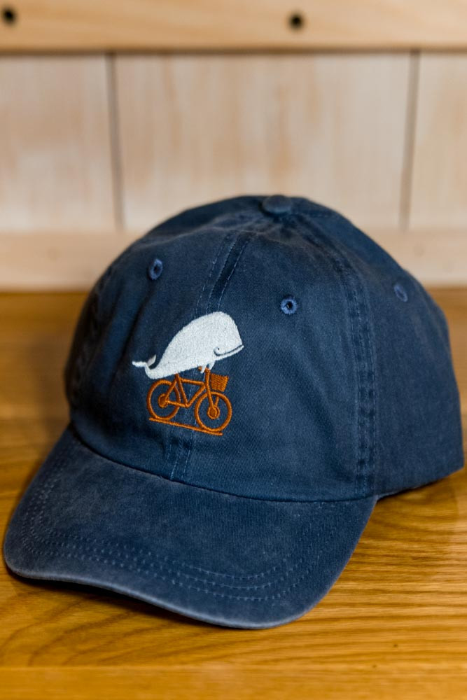 TWGS Embroidered Whale-on-the-bike Logo Baseball Hat - Distressed Navy w/ Orange