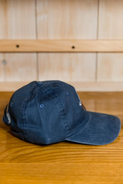 TWGS Embroidered Whale-on-the-bike Logo Baseball Hat - Distressed Navy w/ Orange
