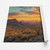 West Texas sunset panorama on a partially unrolled, unstretched printed canvas sheet — illustrative artwork