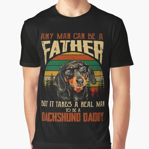 Graphic t-shirt featuring the text "It Takes A Real Man To Be A Dachshund Daddy" with a dachshund illustration.
