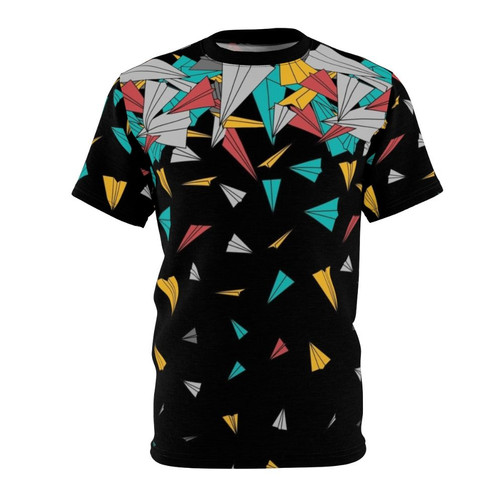 Person wearing a t-shirt featuring a colorful, geometric paper plane design