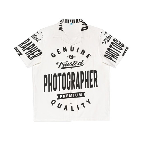 Photographer holding a camera wearing a colorful Hawaiian shirt