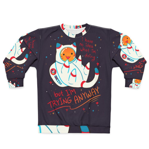 Cat astronaut wearing a cozy sweatshirt with a positive affirmation