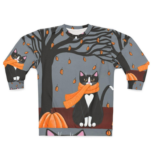 Tuxedo cat on a cozy autumn sweatshirt