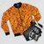 A bomber jacket featuring a cheesy Cheez It design. - Flat lay