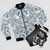 Luxurious white bomber jacket with abstract glass texture and diamond-like pattern - Flat lay
