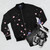Cherry blossom sea slug bomber jacket with a floral and marine life design - Flat lay