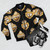 Golden silver metallic pattern with a Mexican heart design on a black bomber jacket - Flat lay