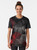 A graphic t-shirt featuring an abstract background of geometric polygon shapes in black, red, and blue colors. - Women