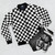 A modern, minimalist black and white checkerboard pattern bomber jacket - Flat lay