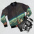 Vintage space-themed bomber jacket with a collage of stars, planets, and a romantic couple holding hands in a surreal, nostalgic design. - Flat lay