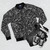 Vegetable pattern bomber jacket with various vegetables like squash, broccoli, onion, garlic, and more. - Flat lay