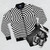 A black and white bomber jacket with a hypnotic spiral design - Flat lay
