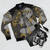 The Witch Gothic Bomber Jacket with ram skull, human skull, and botanical designs - Flat lay