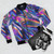 Holographic material bomber jacket with a shiny, glossy texture in purple, pink, blue, and green colors - Flat lay