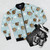 Festive Rudolph the Red-Nosed Reindeer bomber jacket with holiday-themed graphics - Flat lay