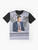 Norm Macdonald wearing a suit and tie while seated at a news desk, graphic t-shirt design - Flat lay