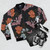 Botanical moths and night flowers pattern on a bomber jacket - Flat lay