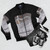 Vintage-style bomber jacket with Genesis "Wind and Wuthering" album cover artwork and other 1970s progressive rock imagery - Flat lay
