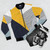 Colorful abstract geometric design bomber jacket with diagonal stripes and triangular patterns - Flat lay