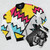 Retro 80s Memphis pattern bomber jacket with abstract, bright color shapes and graphics - Flat lay