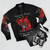 A bomber jacket featuring a cute three-headed puppy design, inspired by Cerberus from the game Hades. - Flat lay