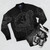 A bomber jacket featuring a graphic design of a raven with mythical Nordic-inspired elements like knotwork, stars, and the North Star. - Flat lay