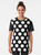 Closeup of a black t-shirt with large white polka dot graphic design - Women