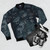 Vintage 1958 bomber jacket with a Lego-inspired building brick and patent blueprint design in blue. - Flat lay