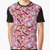 A pink graphic t-shirt featuring Kiwiana elements like bees, chocolate, sweets, and fish.