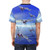 Model wearing a colorful t-shirt with a vibrant dragonfly and abstract pattern design - men back