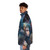 Model wearing a puffer jacket featuring mythical sea creatures and fantasy-inspired designs - men side left