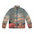Retro futuristic puffer jacket with digital collage design featuring vintage elements, sci-fi, and surreal nature imagery.
