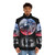 Model wearing a black puffer jacket with a space-themed design featuring stars, planets, and the universe - men front