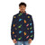 A puffer jacket featuring a whimsical pattern of dinosaurs floating in a galaxy of stars and planets. - men front
