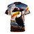A digital artwork t-shirt featuring a pirate toucan bird design against a backdrop of ocean waves and sailing ships.