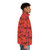 A vibrant orange puffer jacket with autumn leaves design - men side right