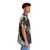 John Waters wearing a black and white Hawaiian shirt - People Pight