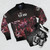 The Warning rock band logo printed on a black bomber jacket - Flat lay