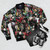 Colorful floral and bird pattern printed on a bomber jacket - Flat lay