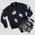 A vibrant digital illustration of adorable space bunnies on a bomber jacket against a starry, cosmic background. - Flat lay