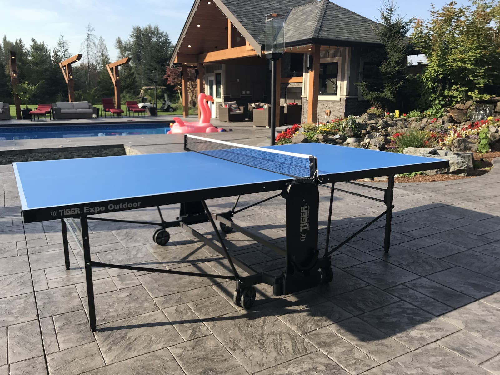 Blue Tiger PingPong Expo Outdoor table beside a pool.