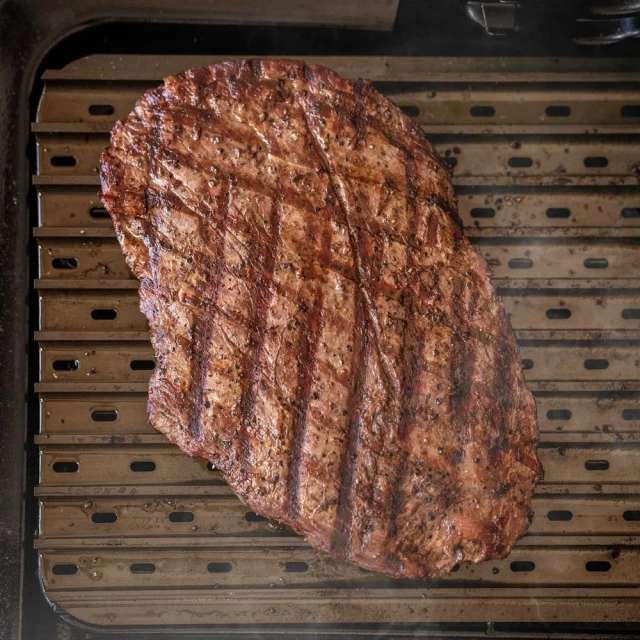 Steak cooking on a Traeger ModiFIRE sear grate.