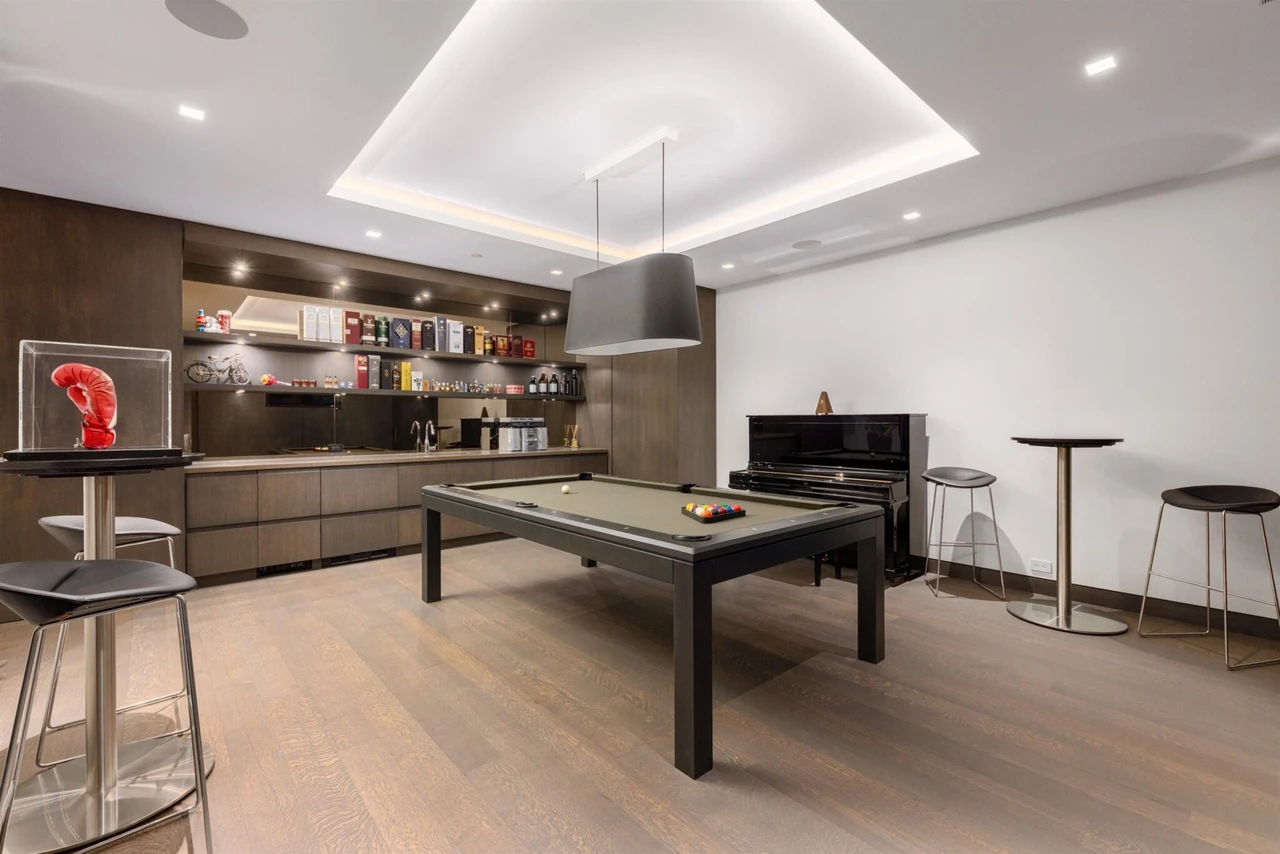 Canada Billiards La Condo Pool Table in a game room with a piano, boxing glove and bookshelf around the room.