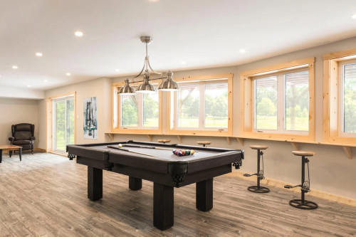 Canada Billiards Invitation Pool Table in a light filled room with widows.